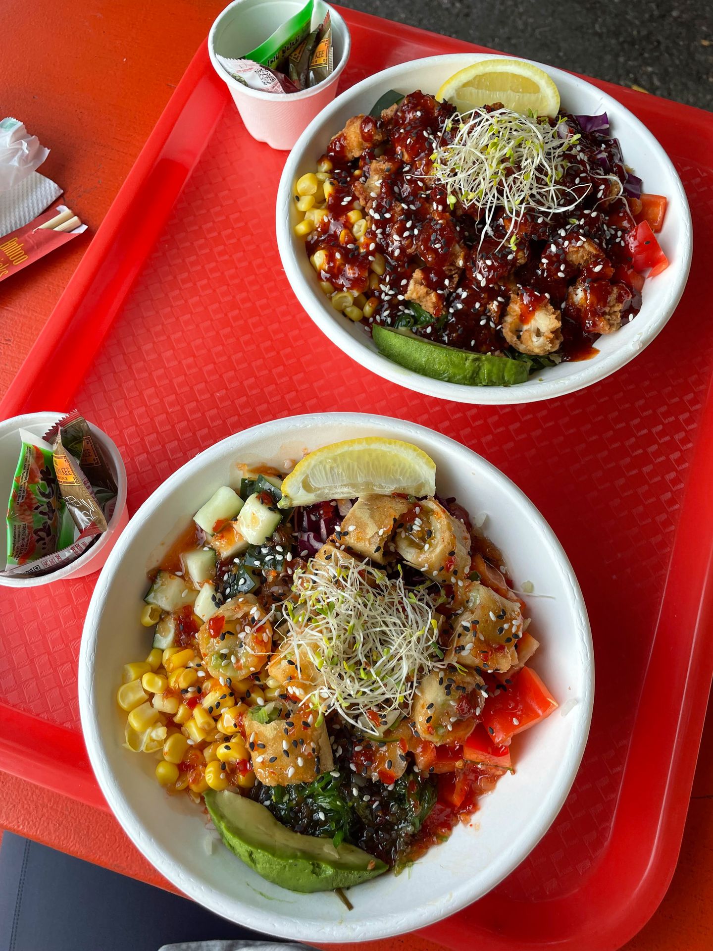 Two bowls with noodles, corn, sauce and more from Scrooge Maki.