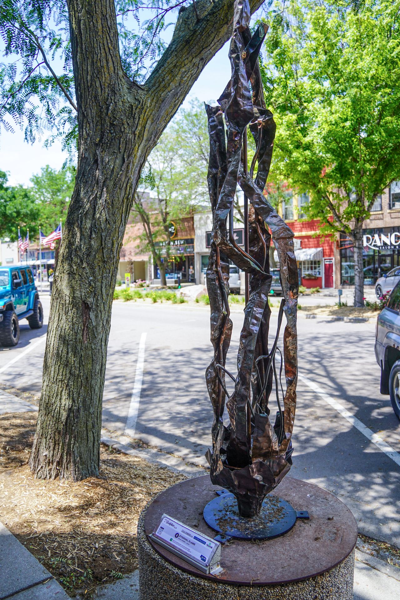 A tall, metal sculpture with organic shapes in Downtown Norfolk