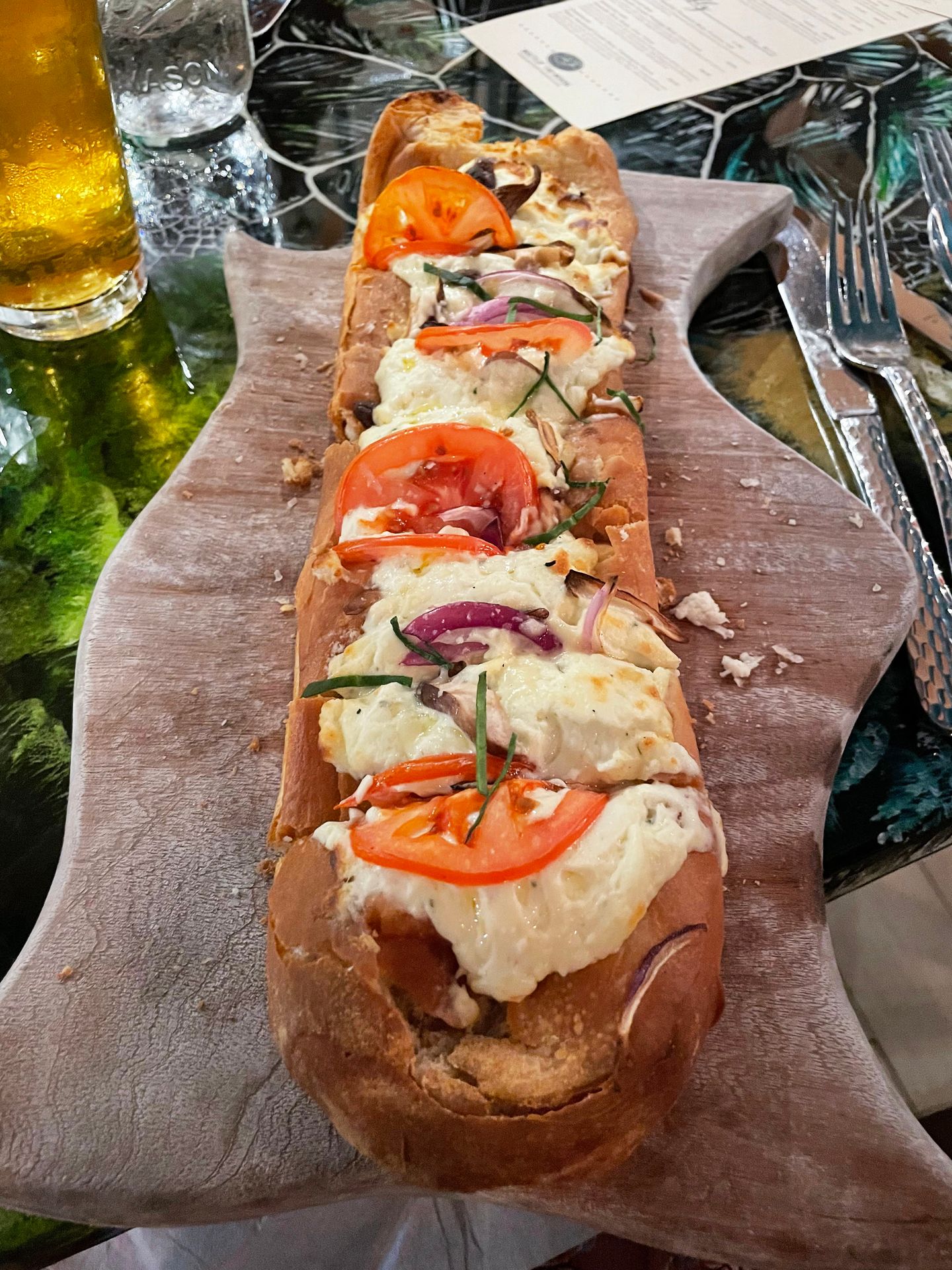 A beneli flatbread with cheese and tomatoes on top