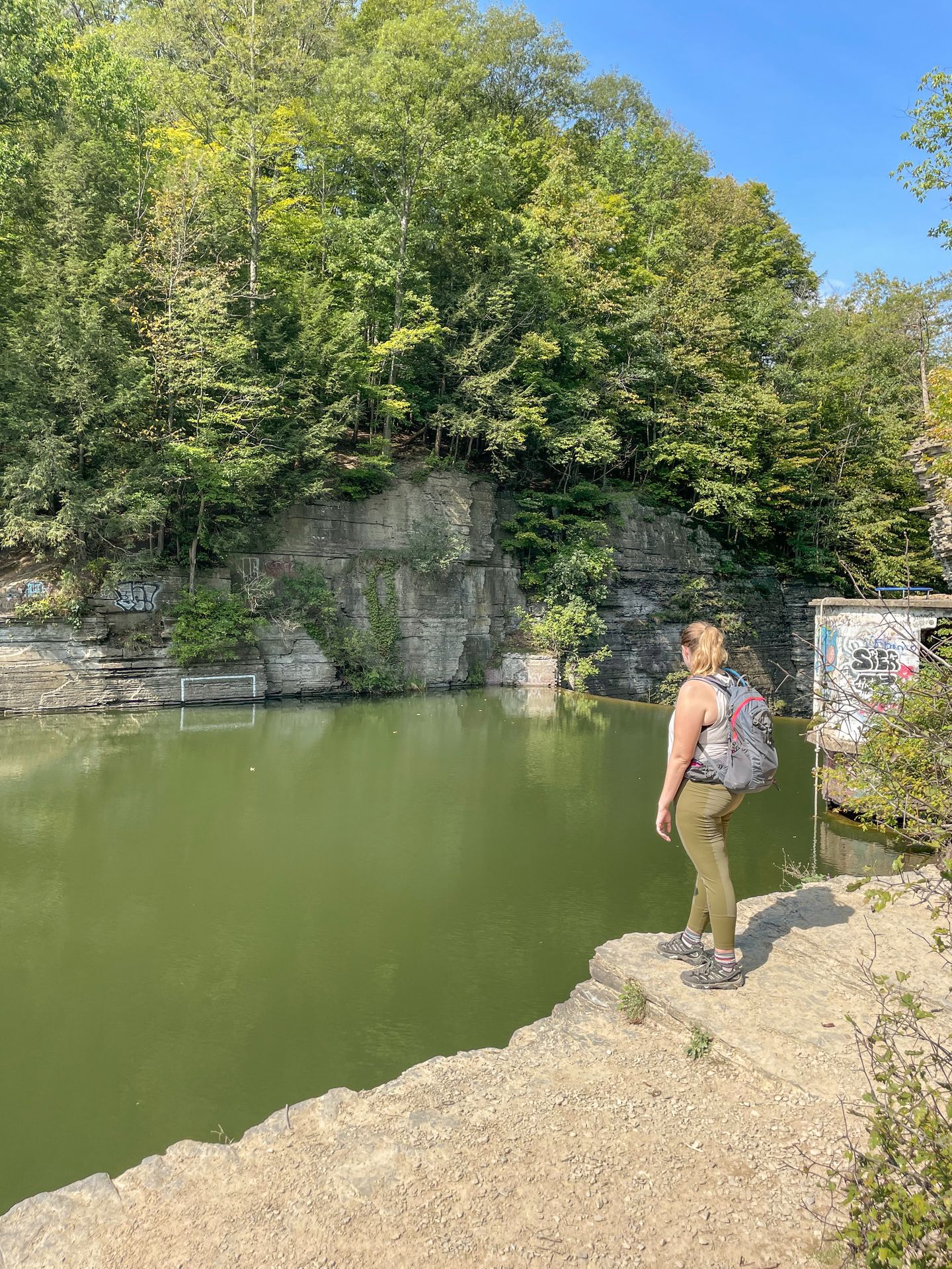 Lydia standing and looking out a reservoir on the Six Mile Creek Trail.
