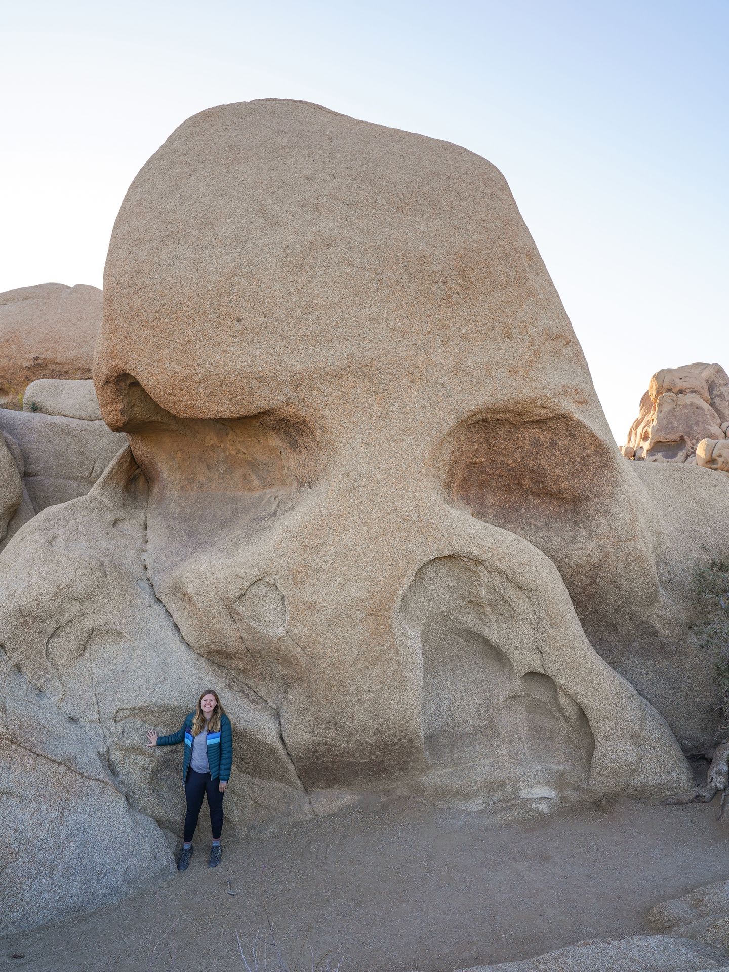 Lydia standing in front of a giant rock that resembles a skull.