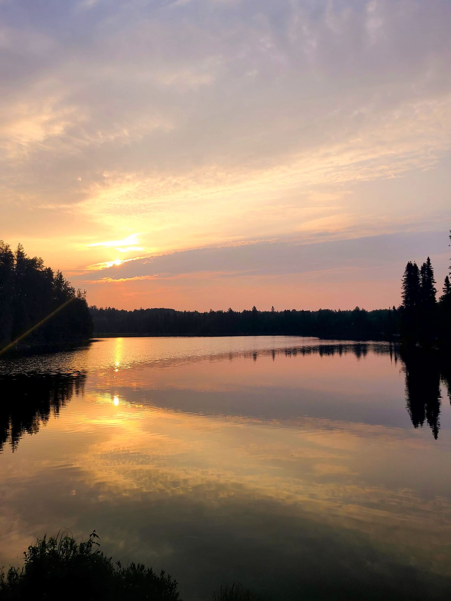 The sunset reflecting on water at Voyageurs National Park