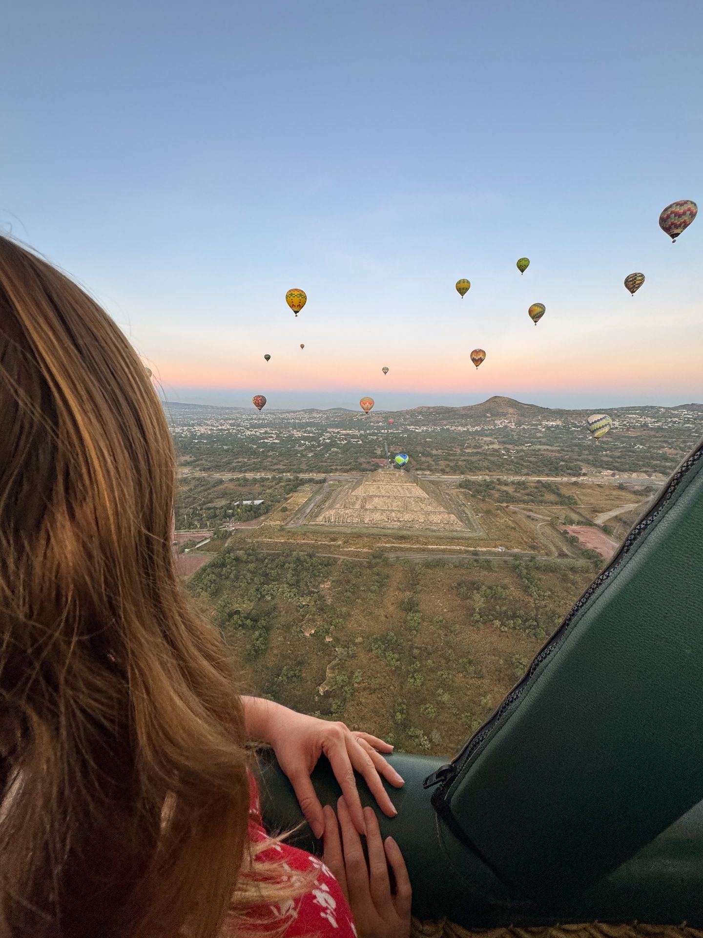 Lydia admiring the view from a hot air balloon over the Teotihuacan Pyramids