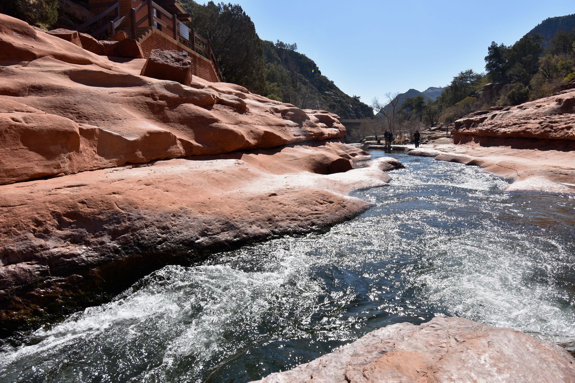 A close up view of blue water cascading through the canyon at Slide Rock State Park.