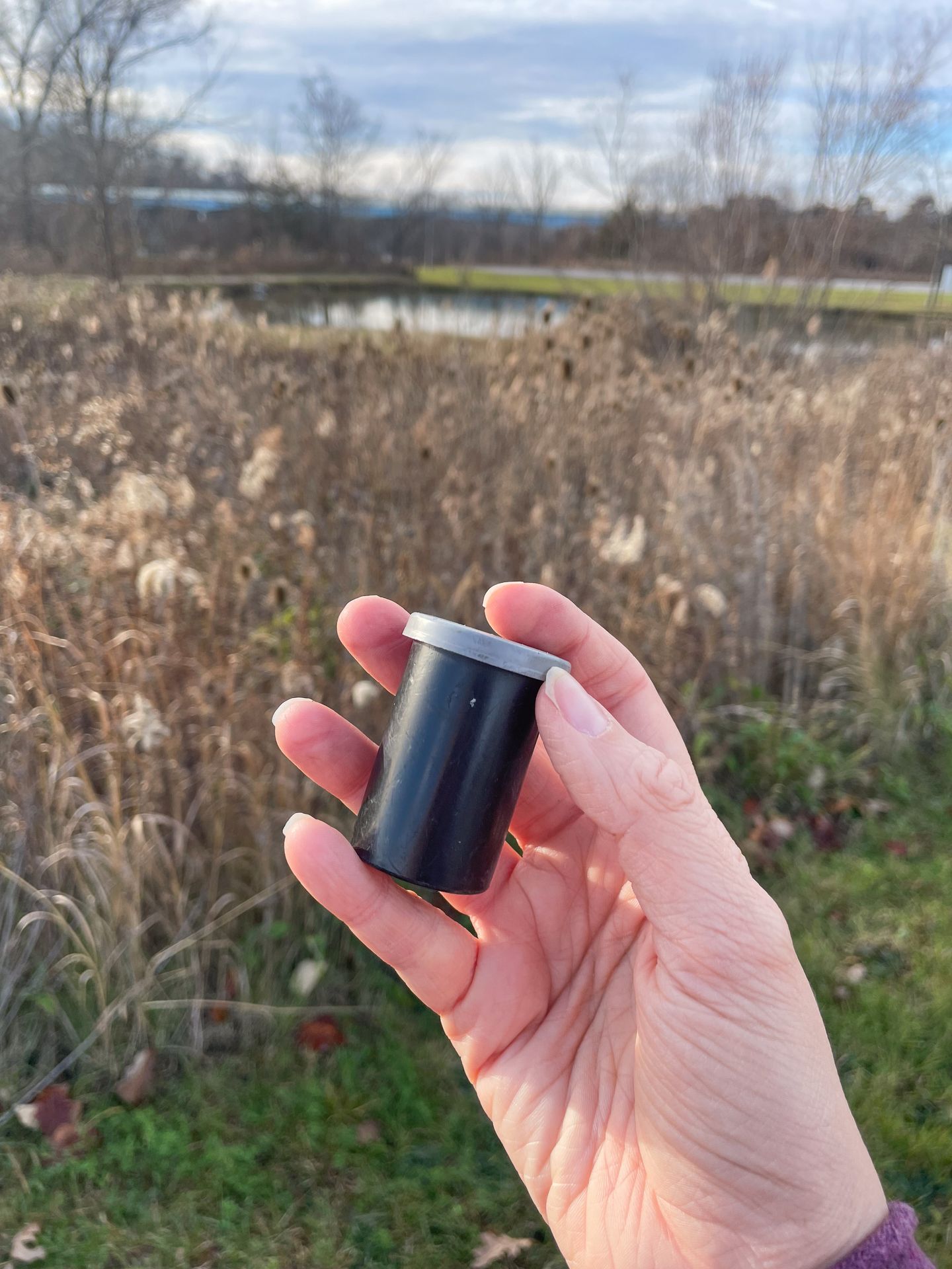 Holding up a small canister