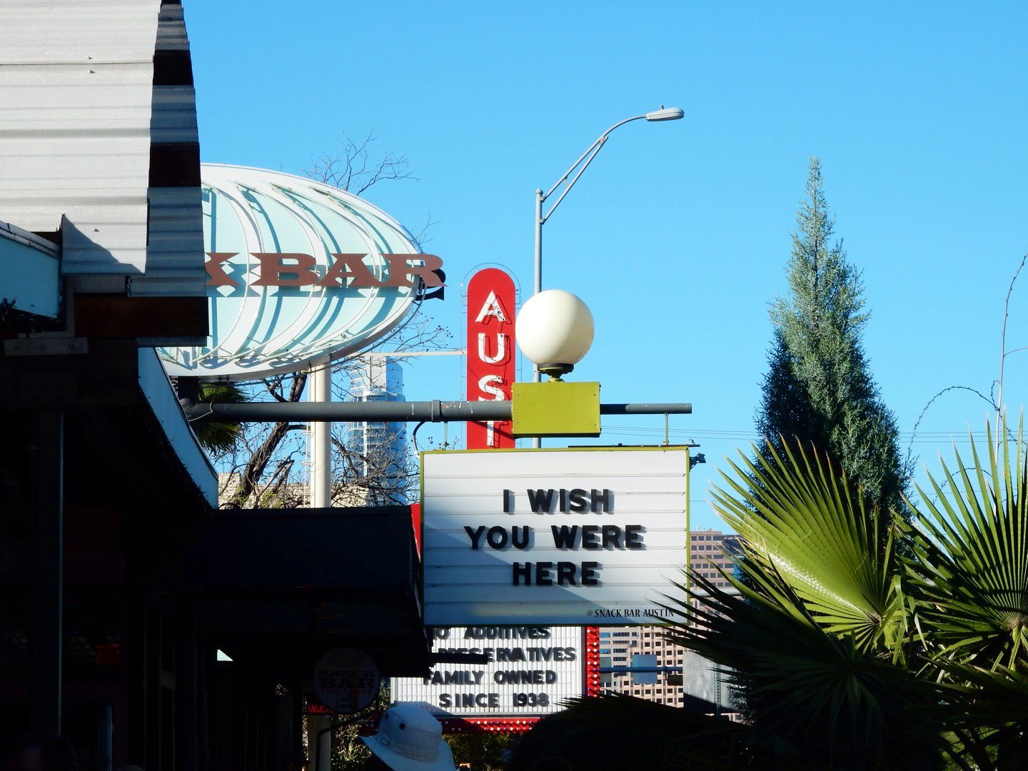 Signs on South Congress Avenue in Austin. One reads "I Wish You Were Here"