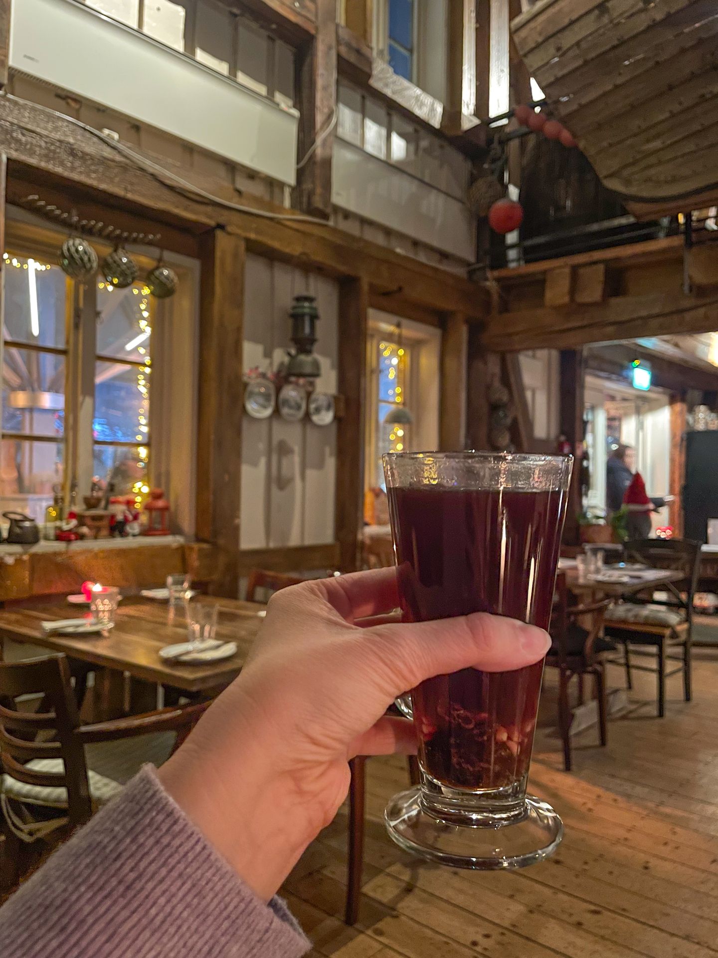 Holding up mulled wine inside the Full Steam Restaurant