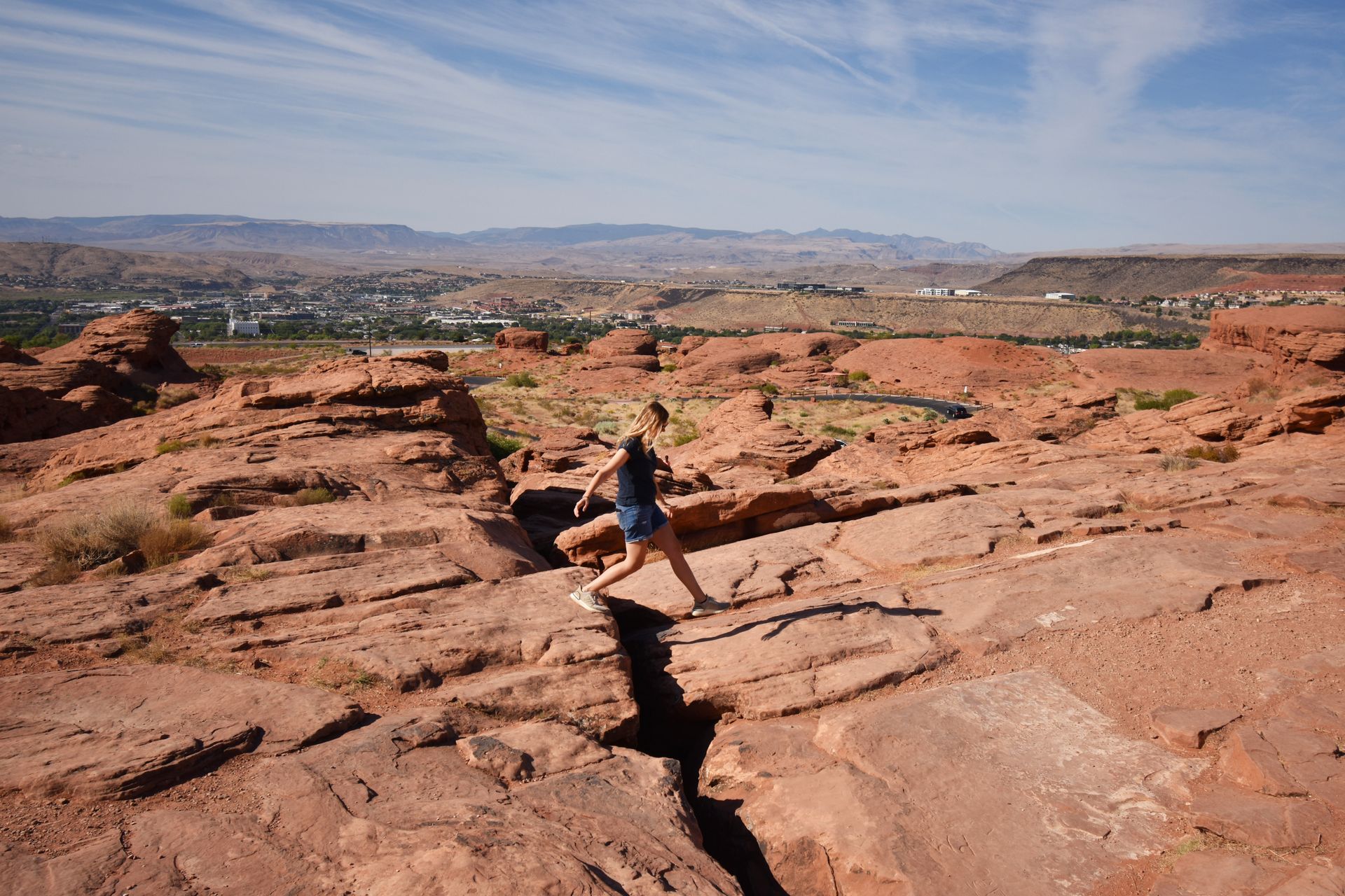 Lydia hiking over an orange canyon at the Pioneer Park in St. George.