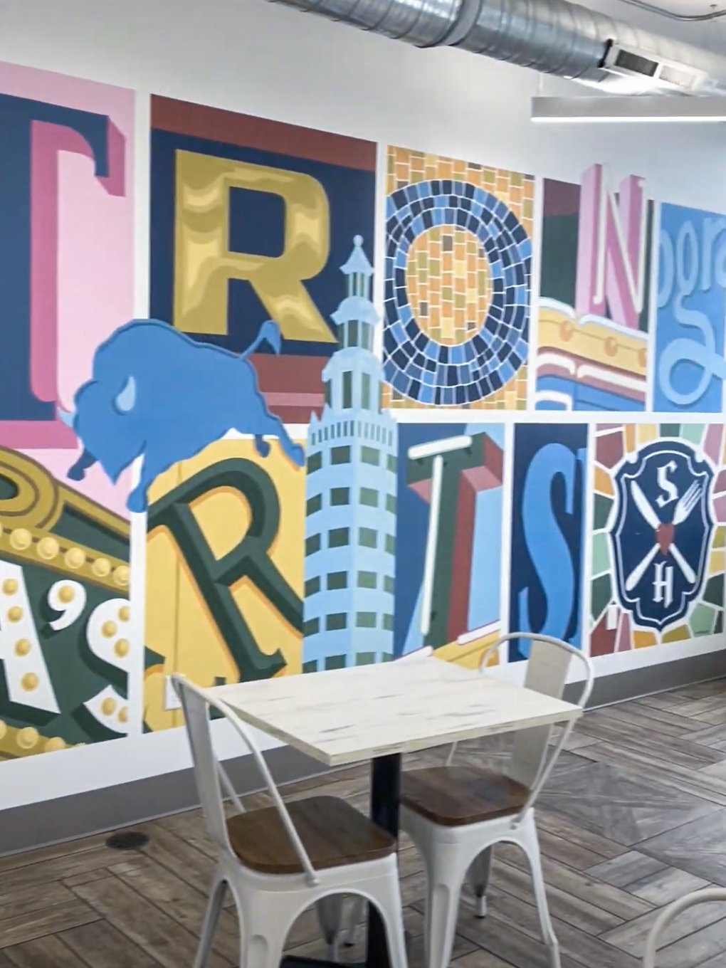 A colorful wall that reads 'Strong Hearts' in abstract letters.