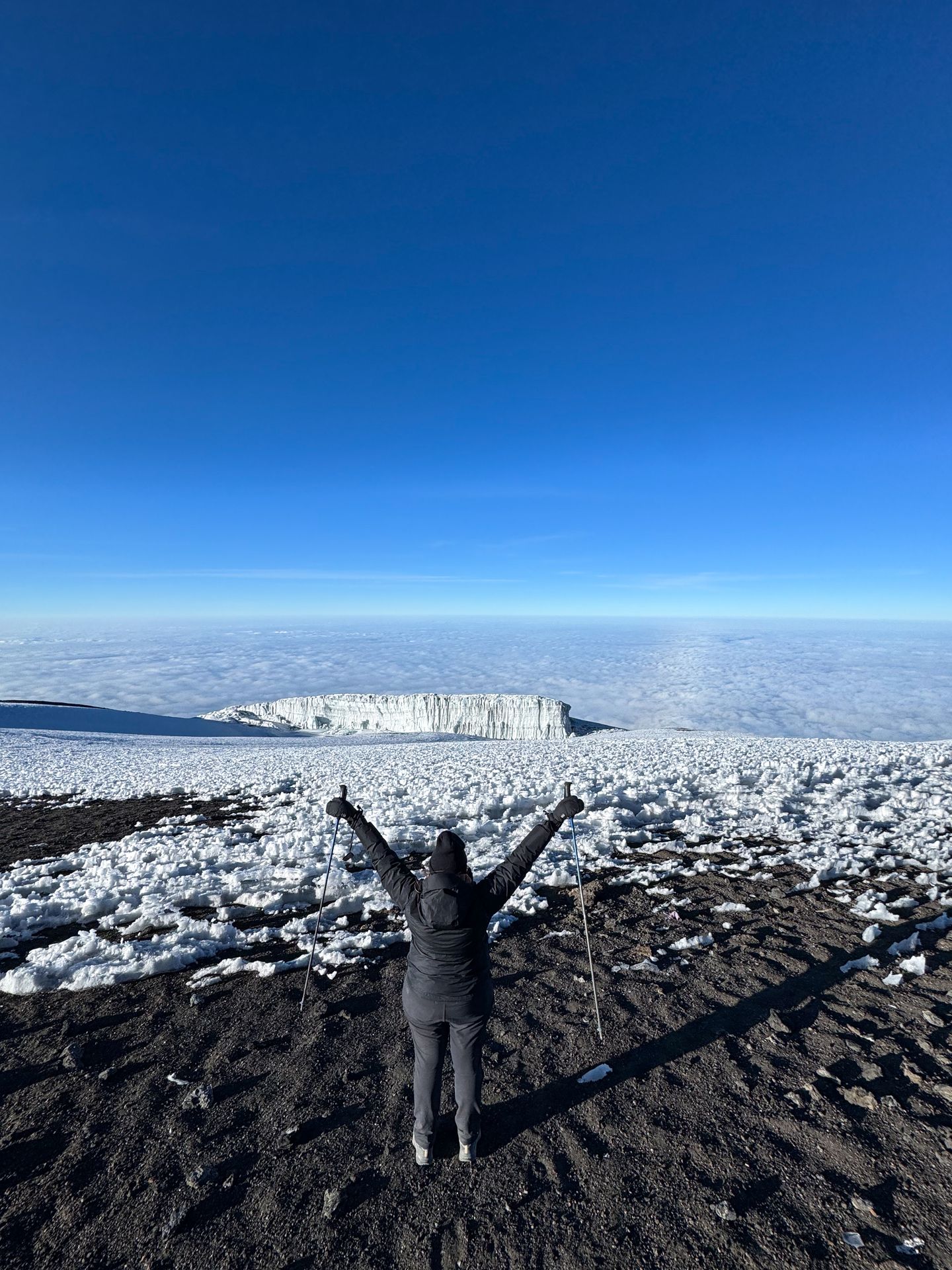 Lydia looking out at an icy view from the summit of Mount Kilimanjaro