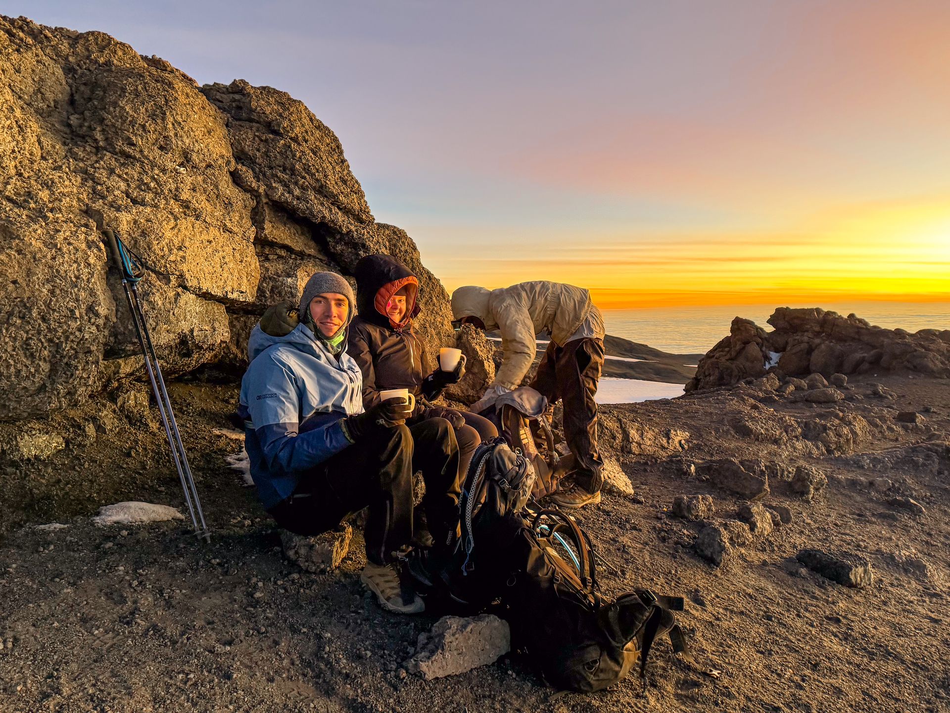 Lydia and Joe sitting and drinking hot drinks on their up to Kilimanjaro