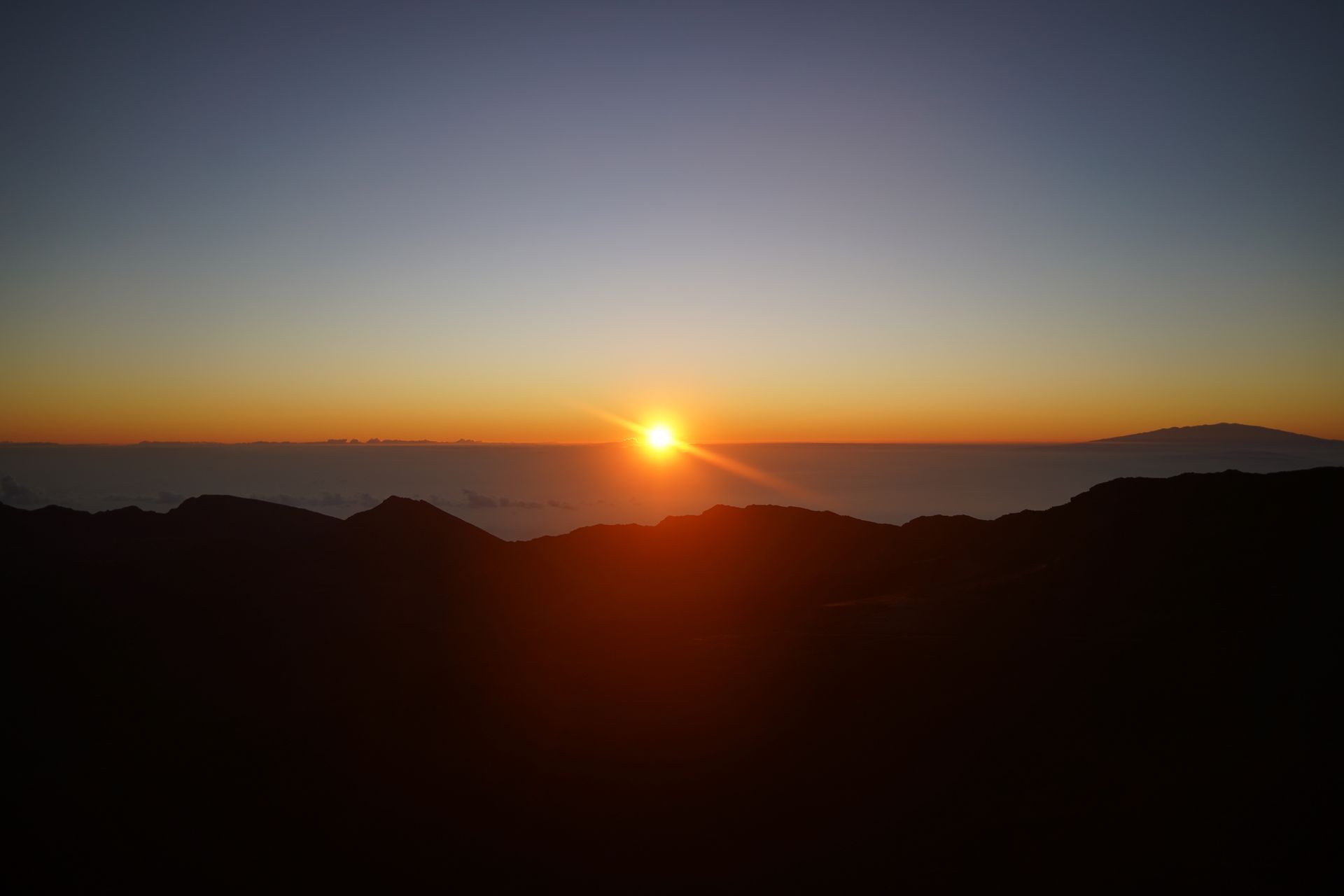The sun rising over a crater in Haleakala