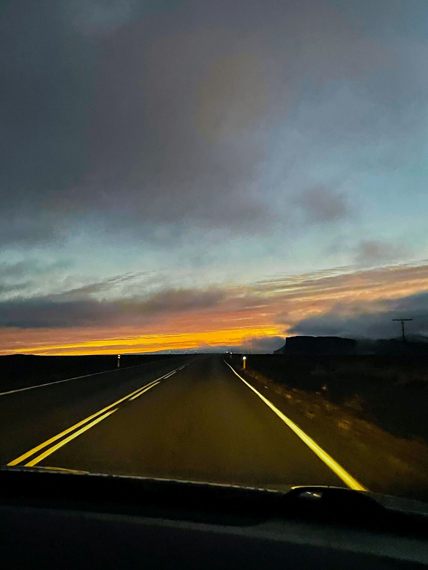 Driving with a setting sun in the distance.