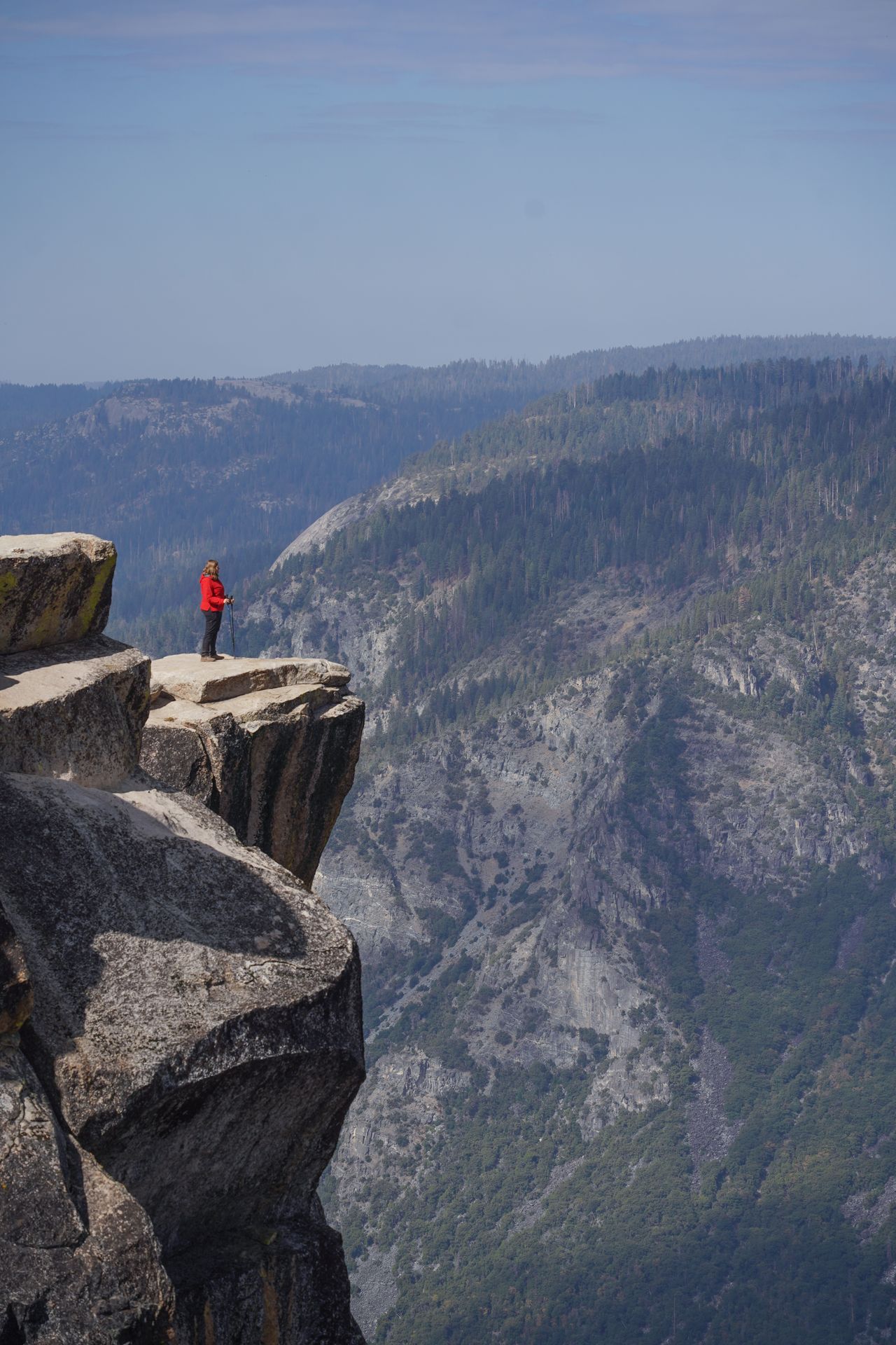 Lydia standing on a ledge at Taft Point