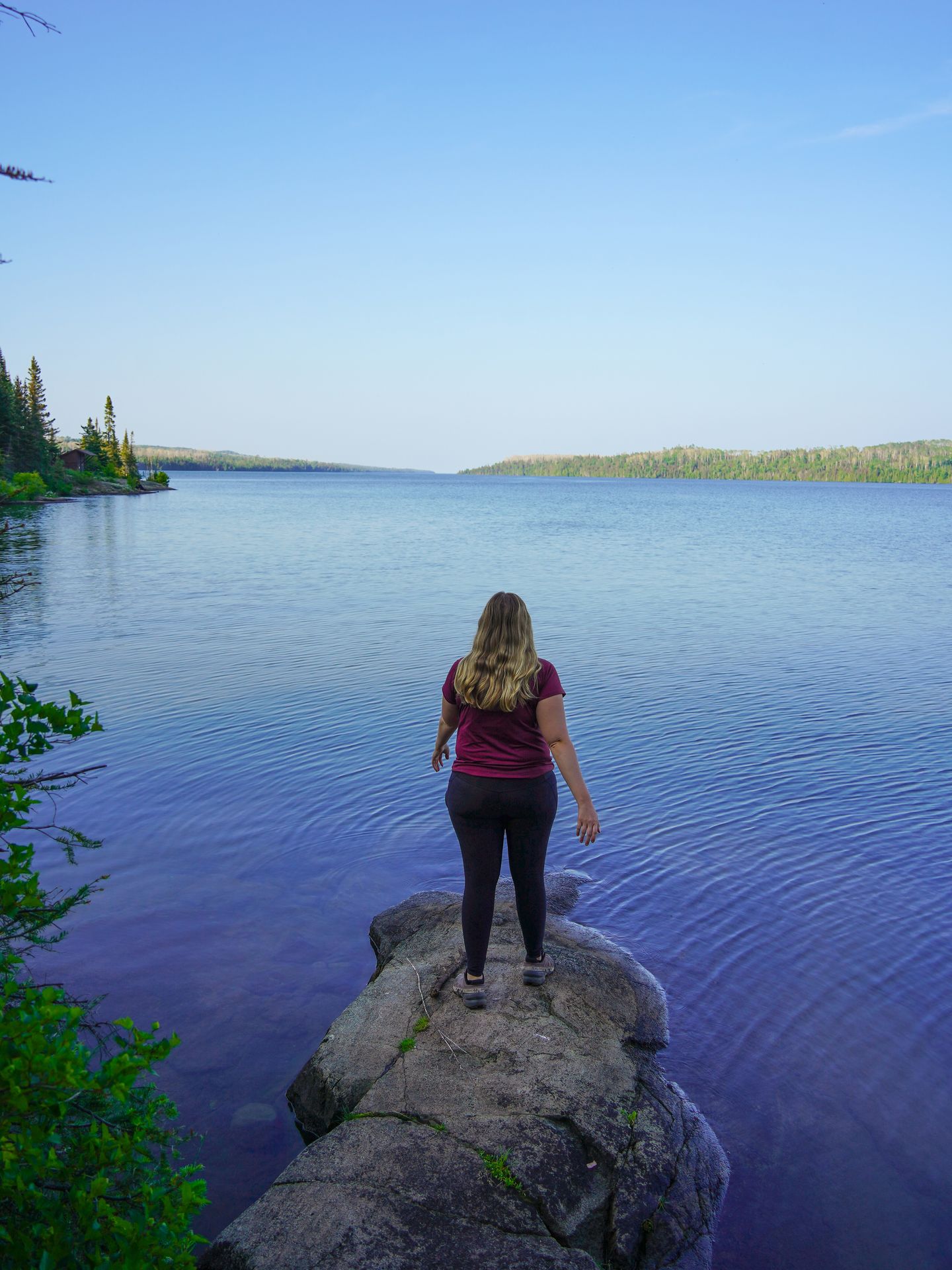 Lydia standing on a rock at the Three Mile Campground.
