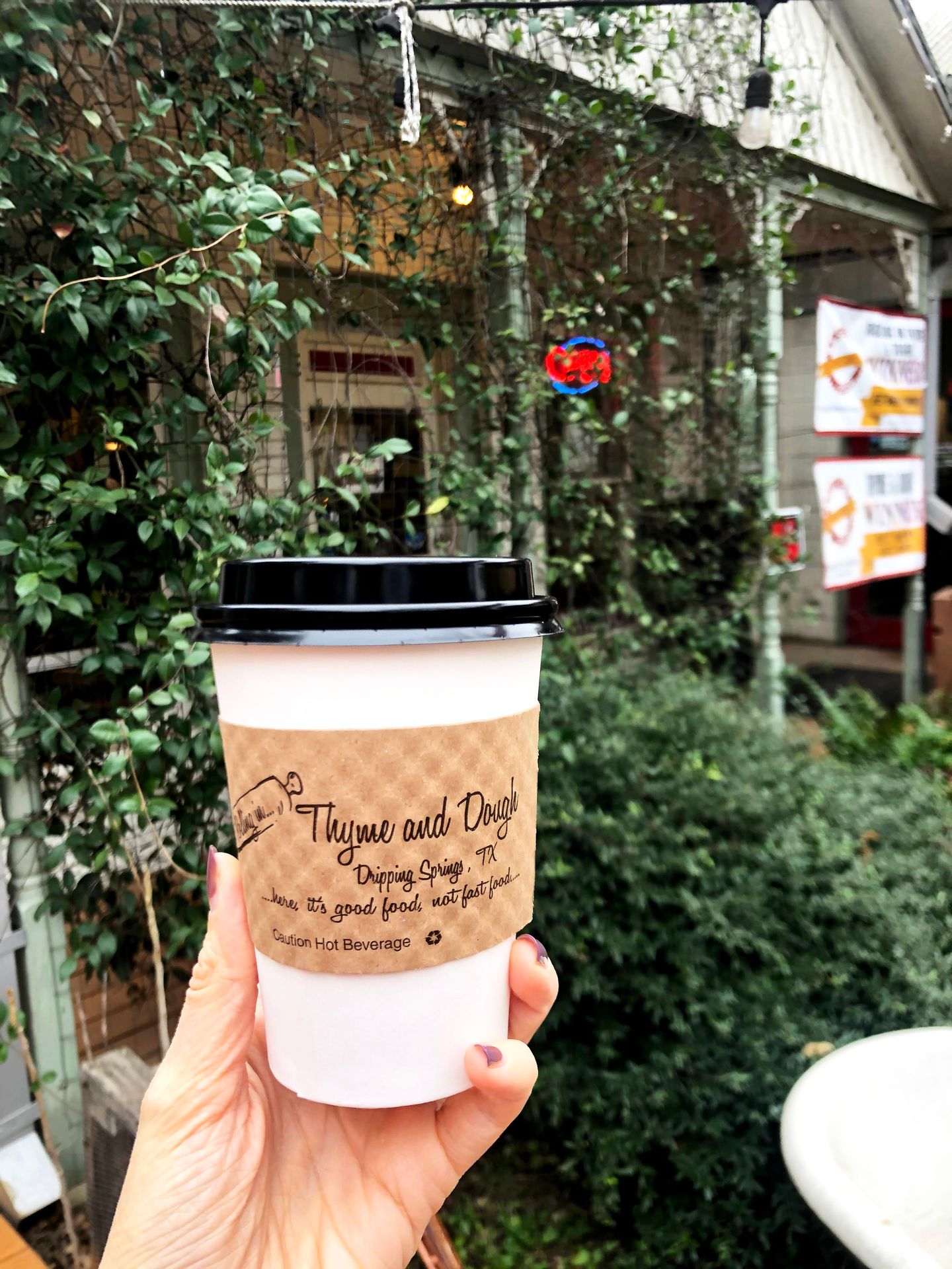 Holding up a coffee cup from Rolling in Thyme and Dough.