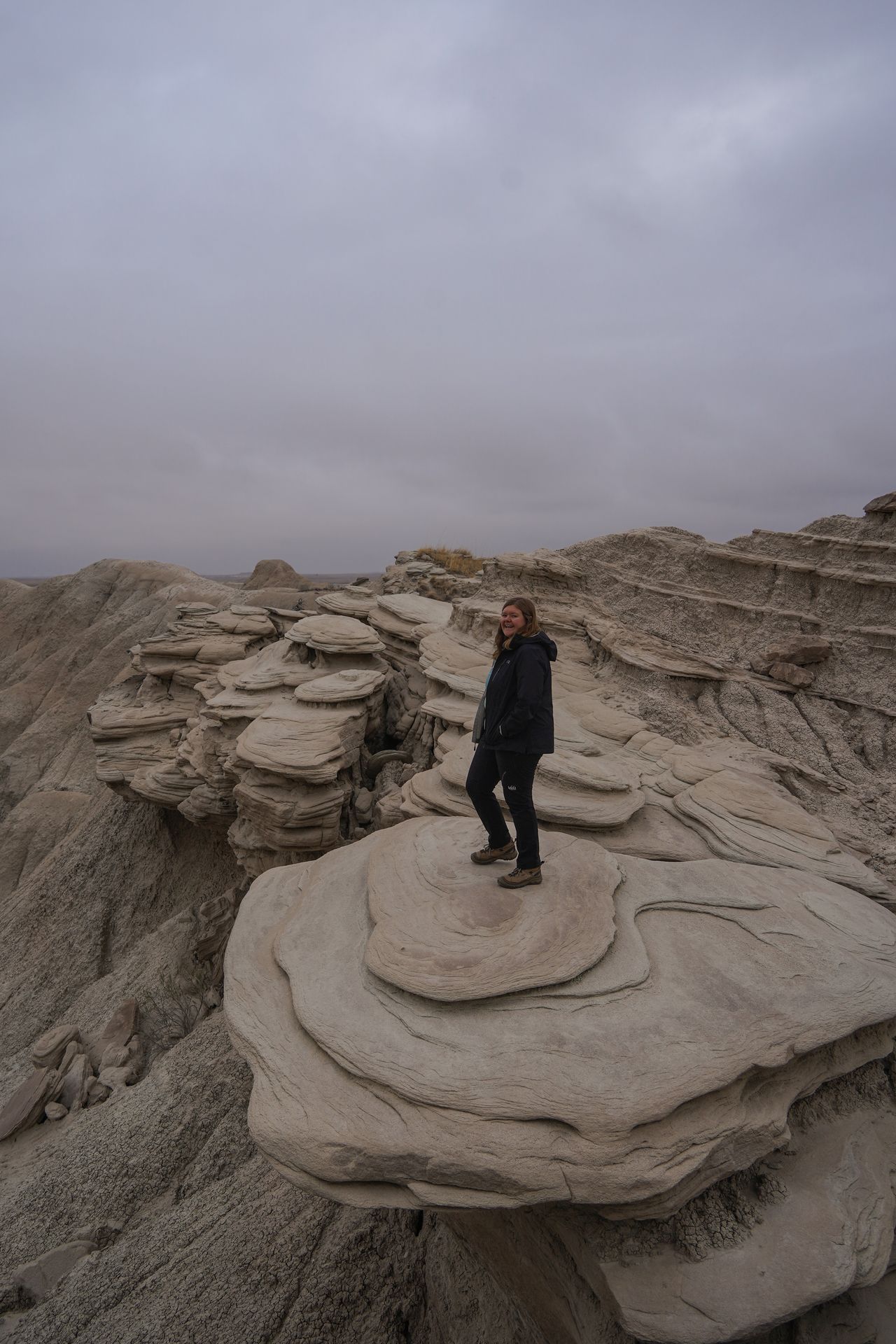 Lydia standing on a round rock, with several other round rocks behind her