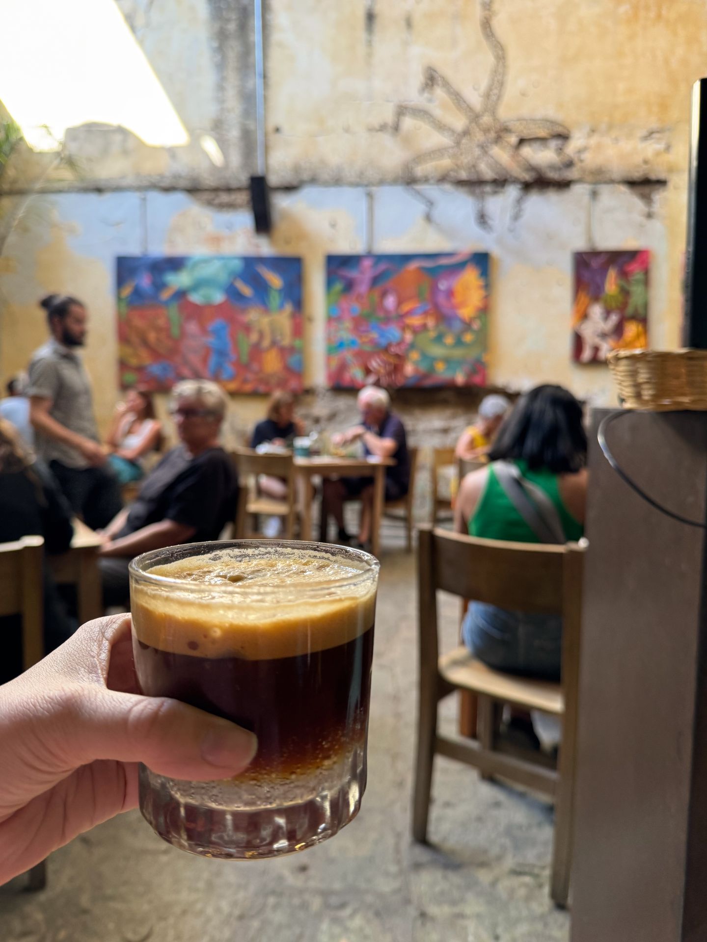 Holding up a drink in the courtyard of Boulenc