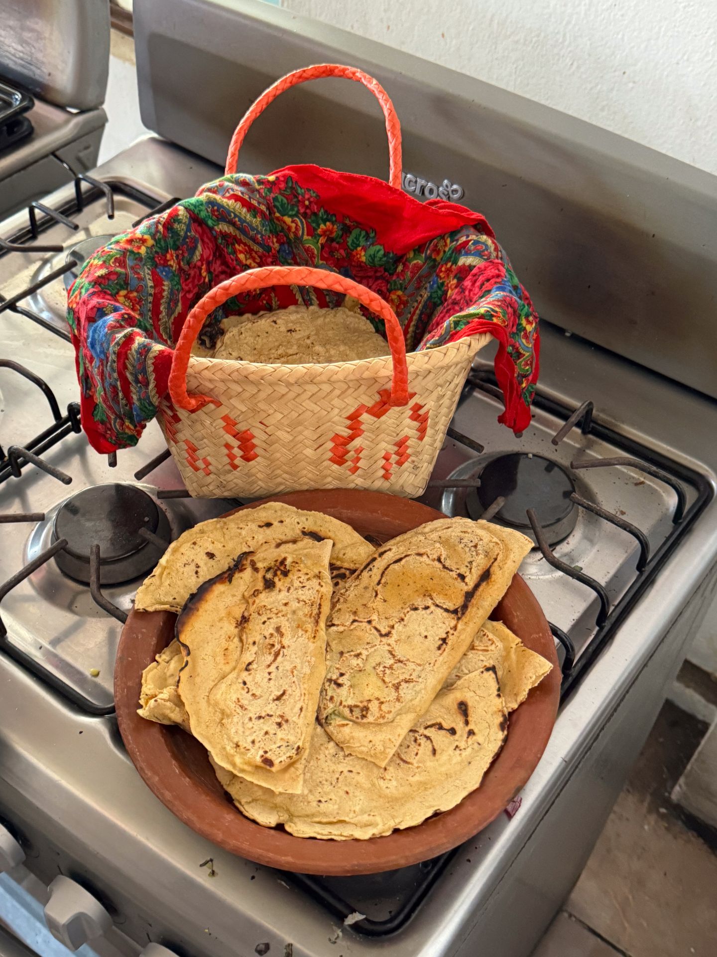 A basket of tortillas and a plate of quesadillas