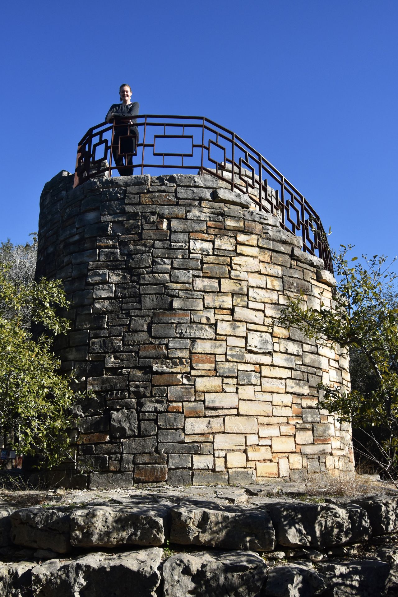 A tower made of stone with Lydia on the top.