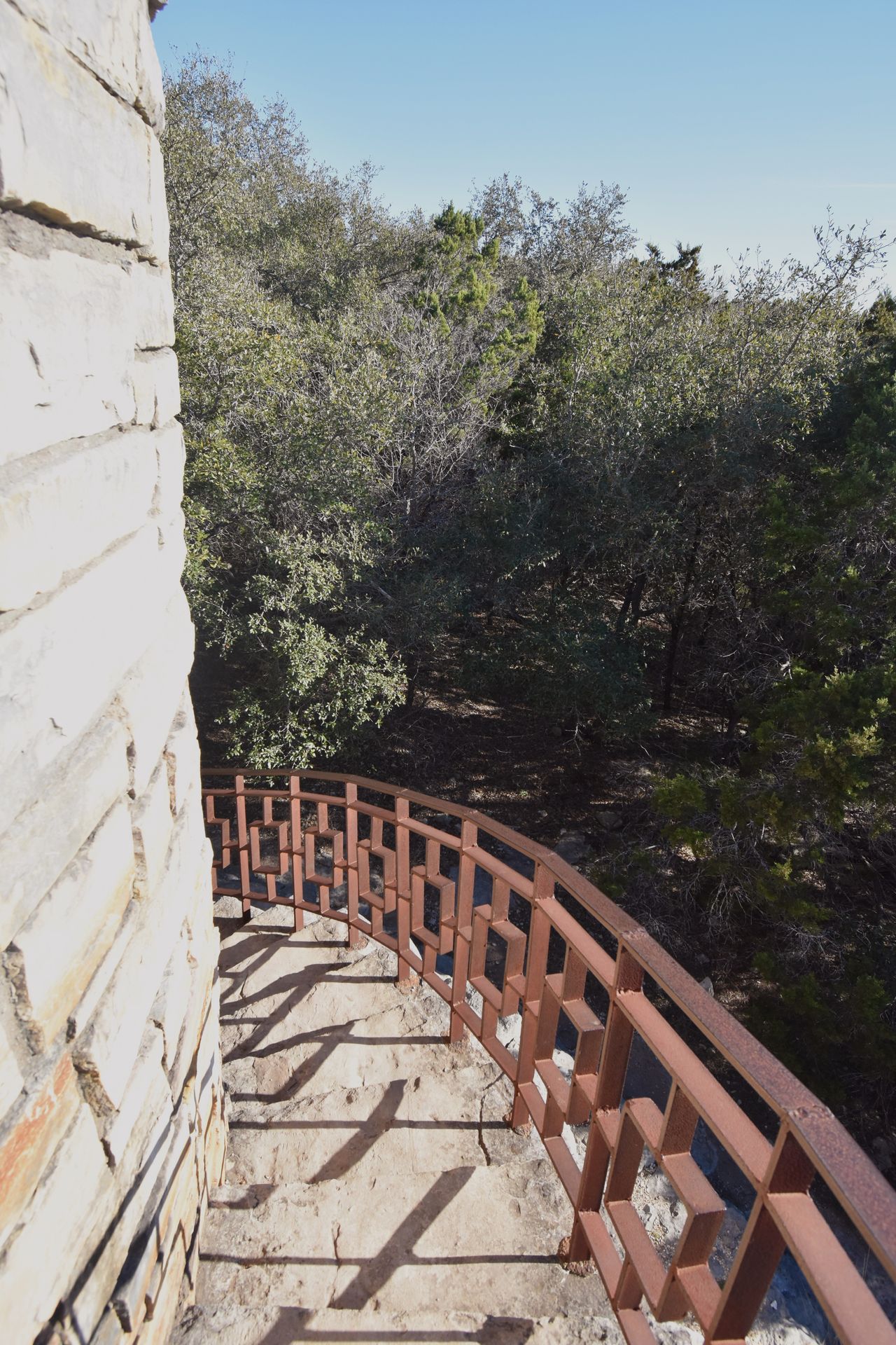 A view of the side of the Rock tower. There is a red railing.