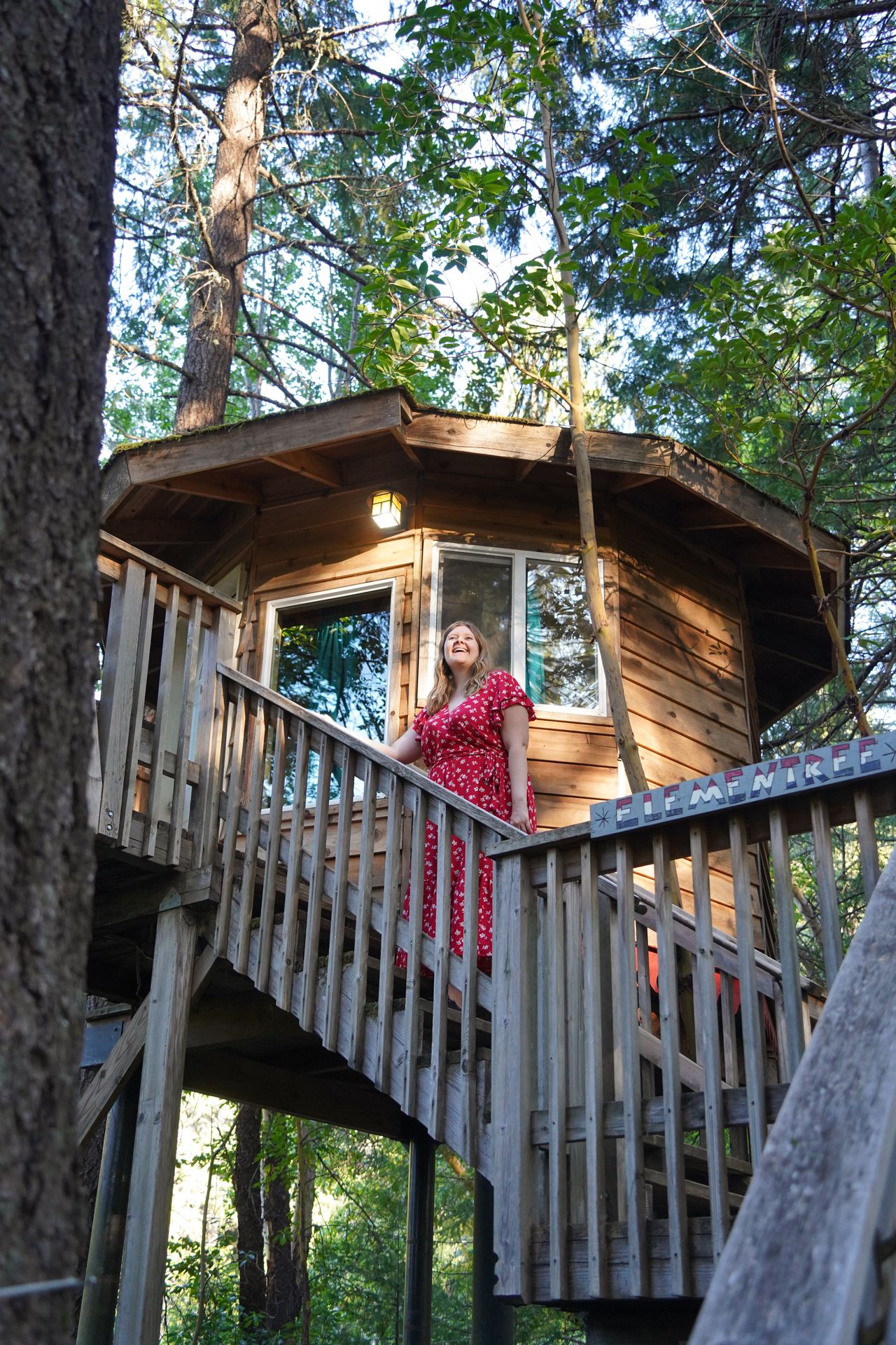 Lydia on the stairs leading up a treehouse in Cave Junction