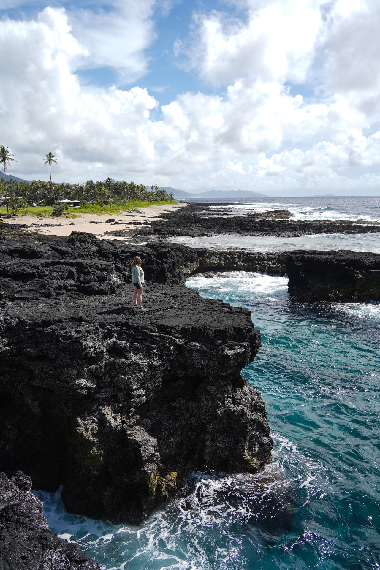 Lydia standing on lava rocks at the Turtle and Shark Viewpoint
