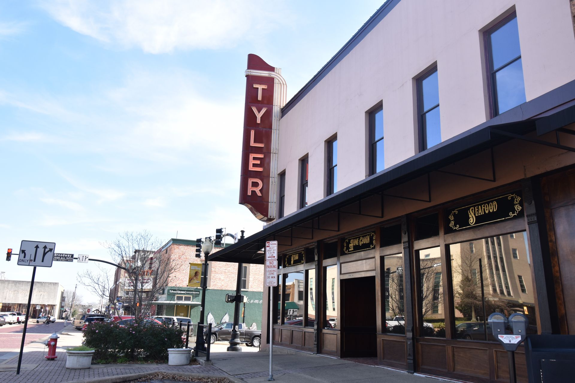 A corner in downtown Tyler with a red sign that reads "Tyler"