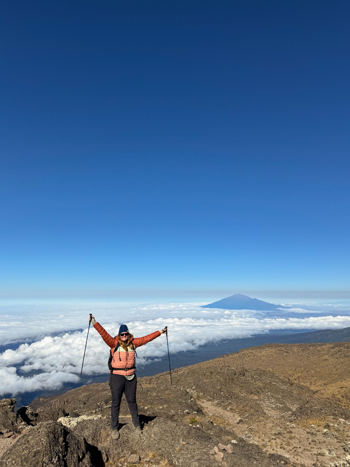 Lydia with her arms in the air during the Mt Kilimanjaro trek