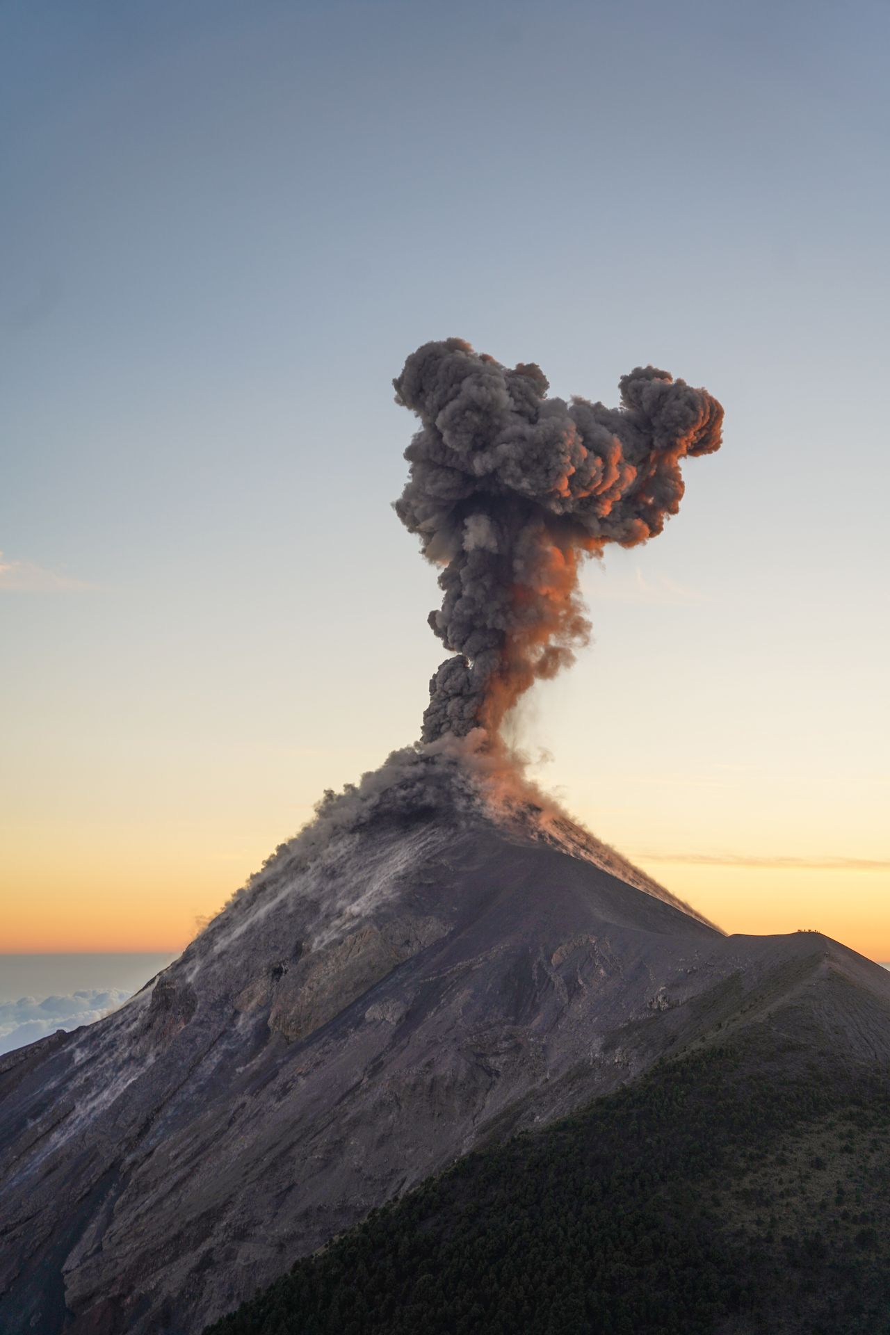 Fuego mid-eruption, with a big plume of smoke above it