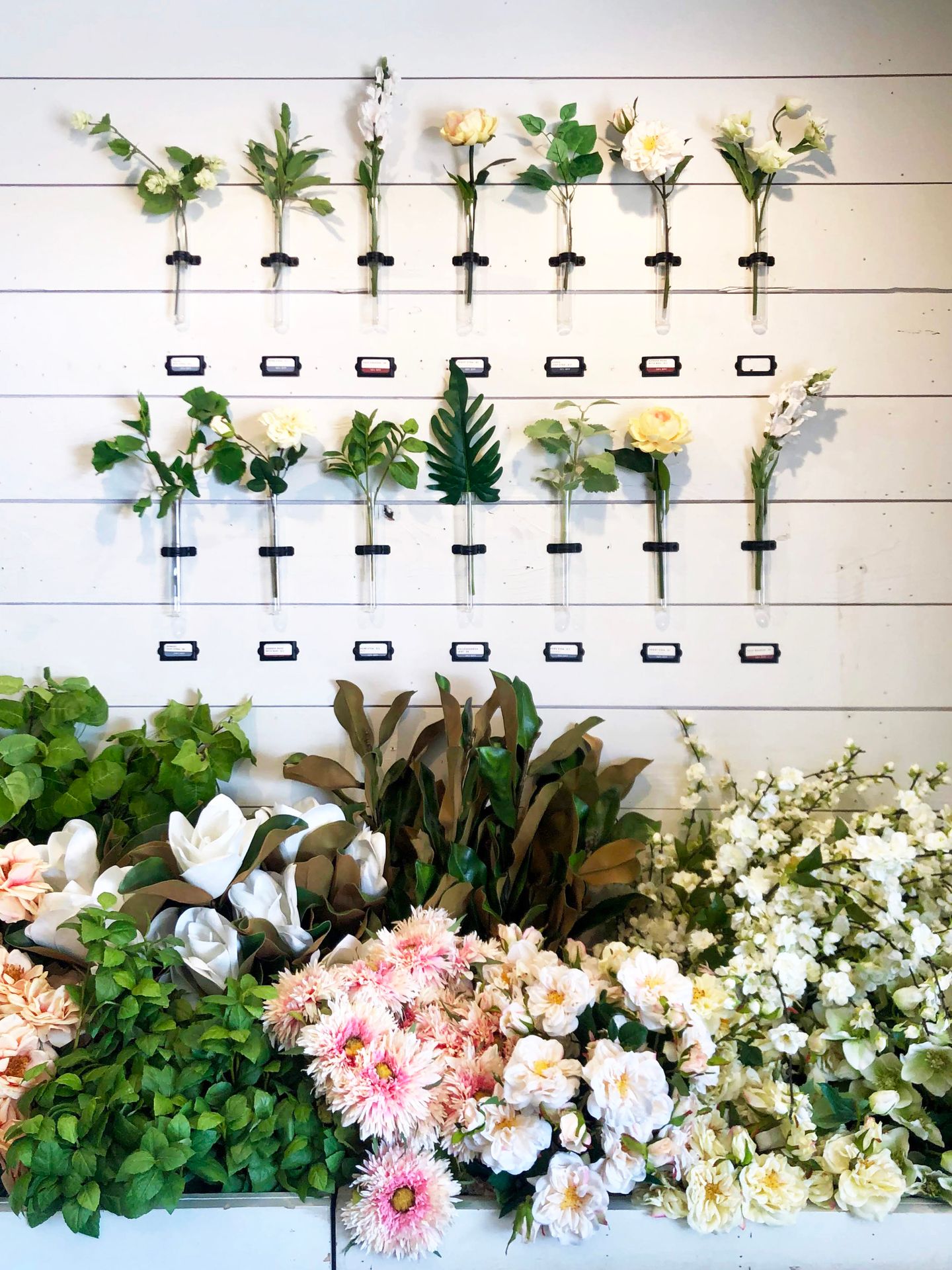 A wall of flowers and various greenery at the Magnolia Silos.