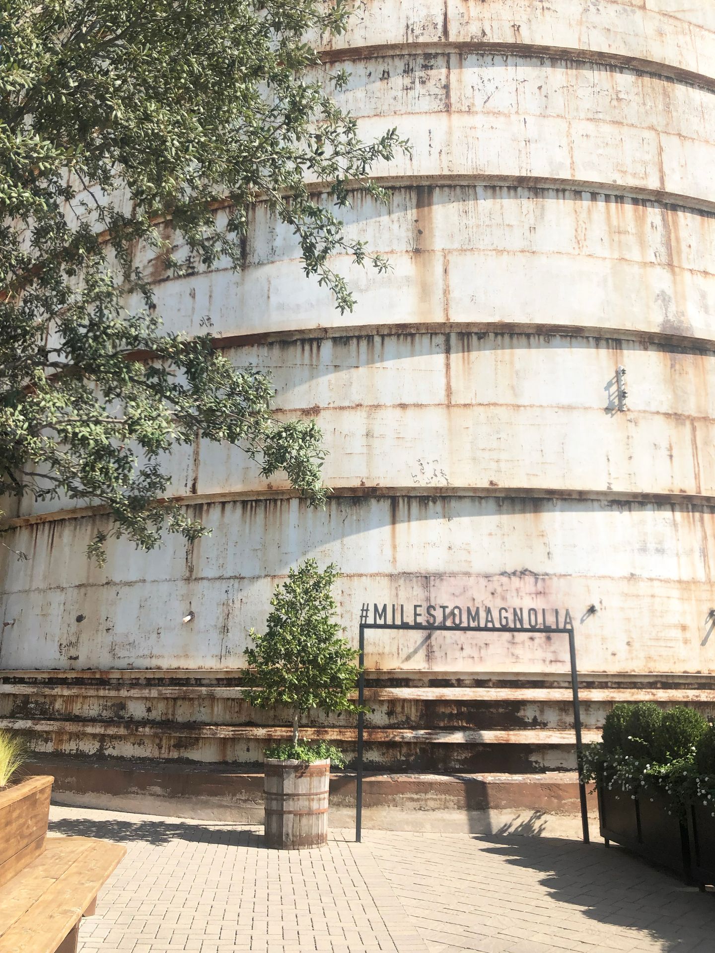 A silo at the Magnolia Silo with a photo reading 'Miles to Magnolia'