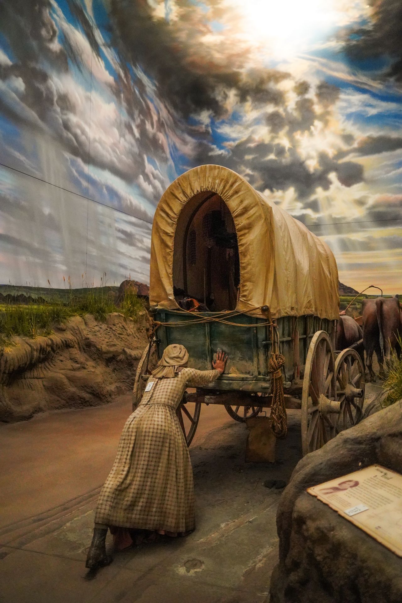 The figure of a women pushing a covered wagon inside The Archway Museum