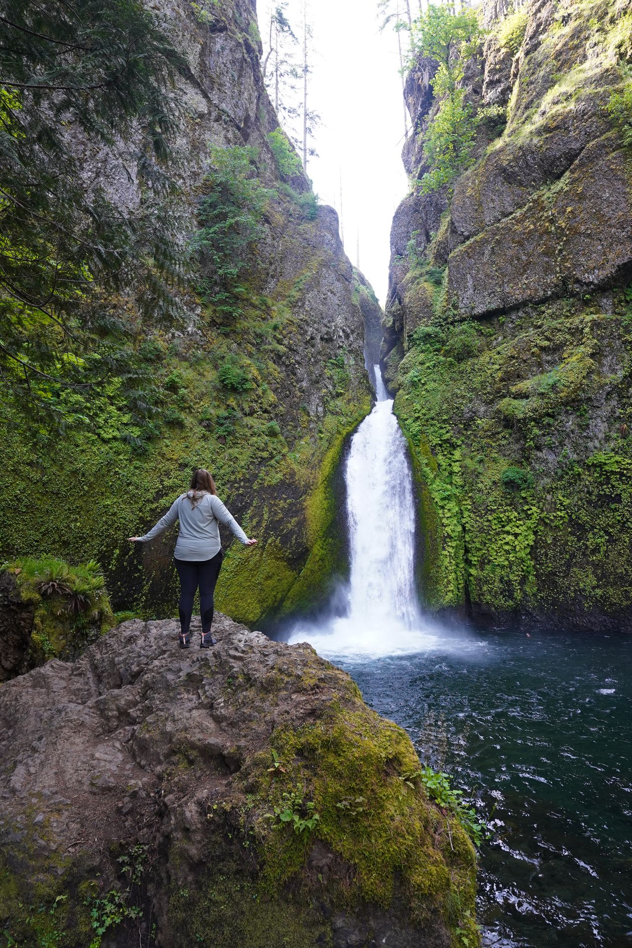 Lydia standing on a rock looking out at Wahclella Falls