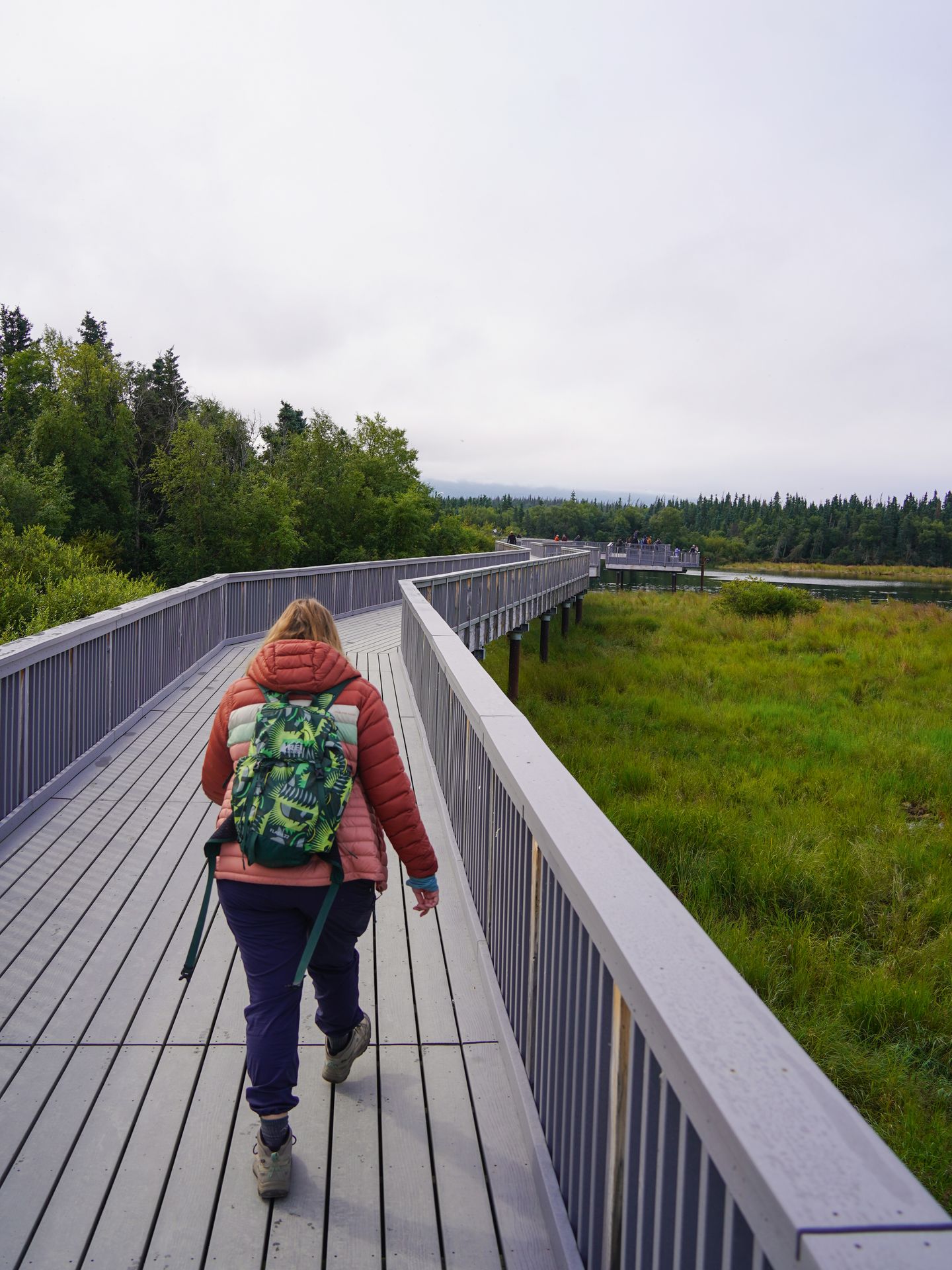 Lydia walking on a boardwalk on the way to the view of Brooks Falls