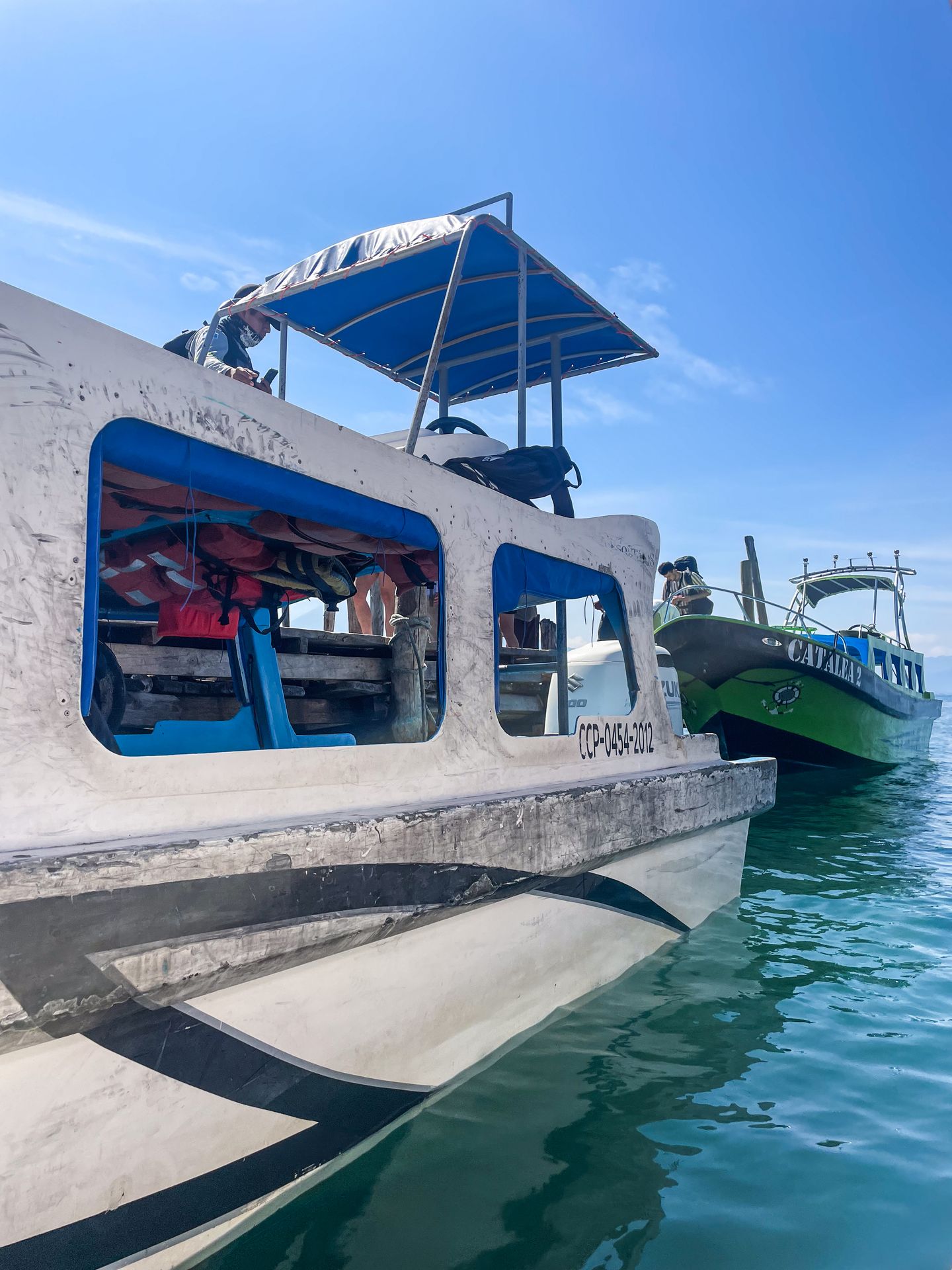 Two water taxi boats parked along a dock on Lake Atitlan