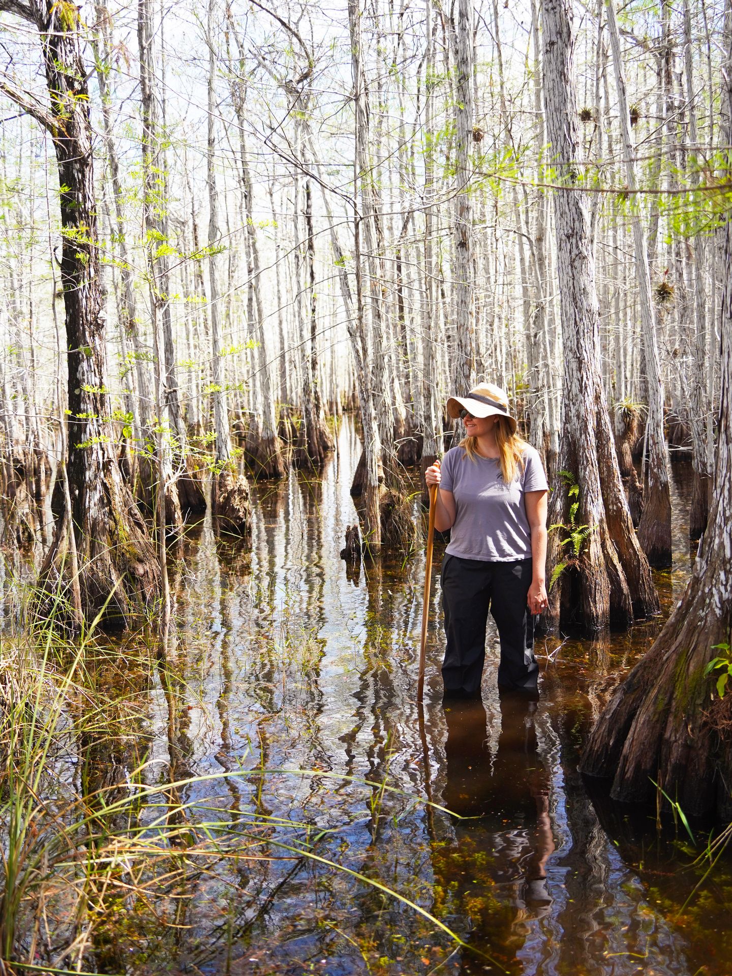 Lydia standing knee deep in water while on a ranger-led wet walk.