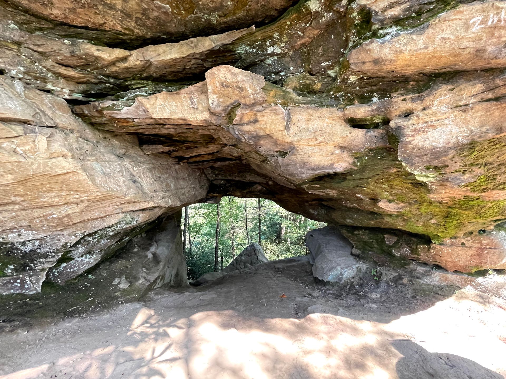 A rock face with a small arch in it