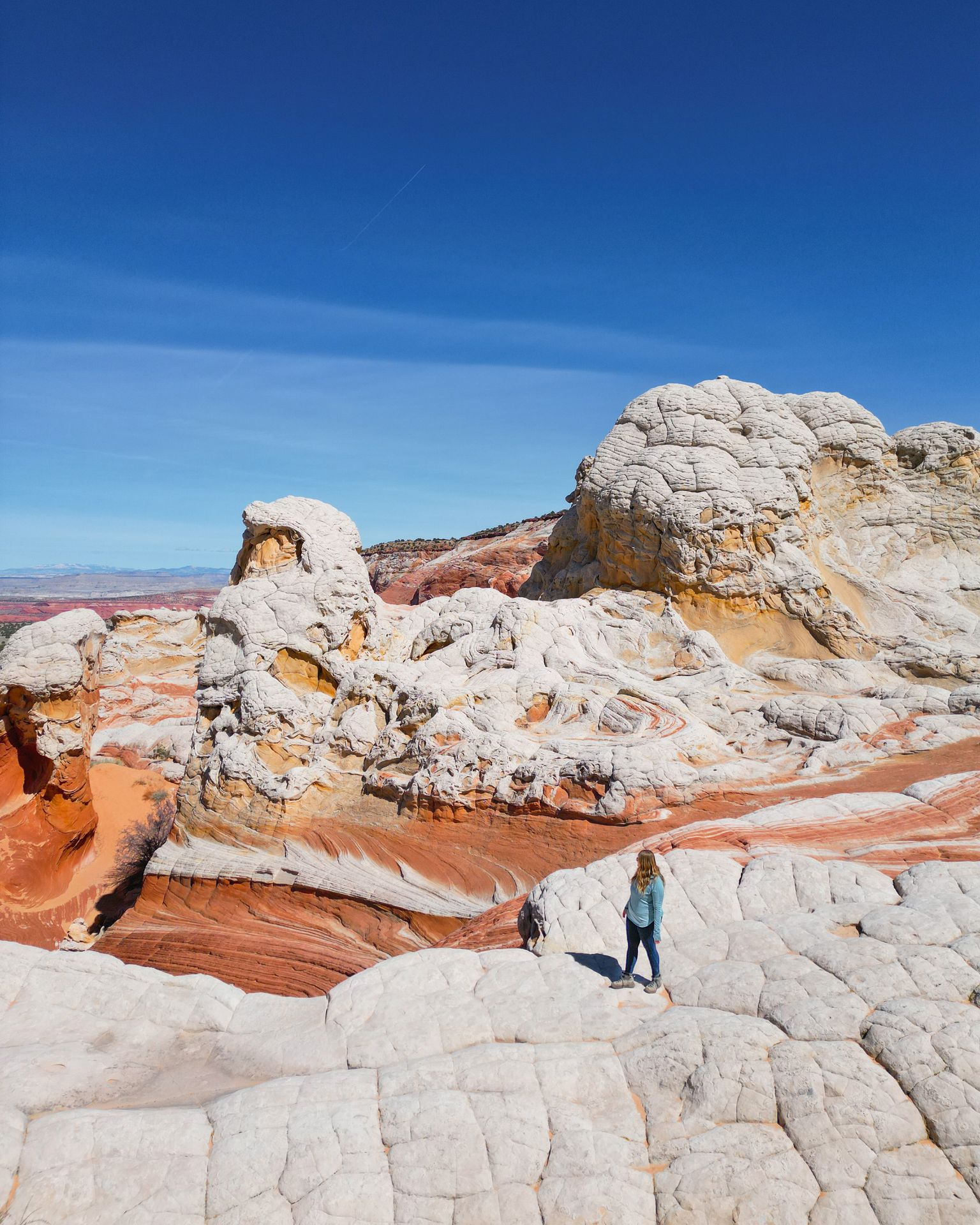 Lydia standing on white rocks that resemble the texture of a giant brain
