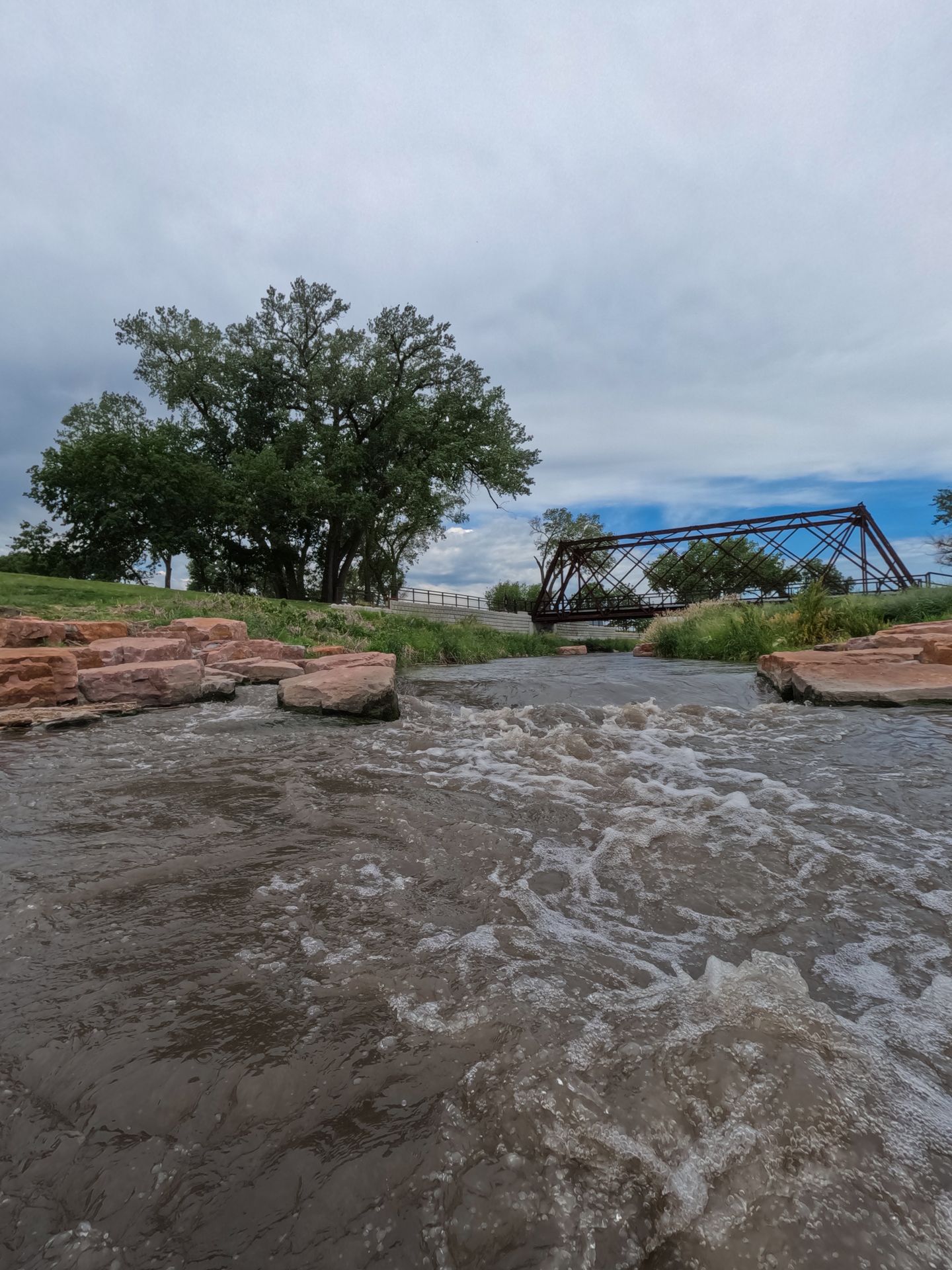 A area with rapids and a bridge in the distnace on the Elkhorn River