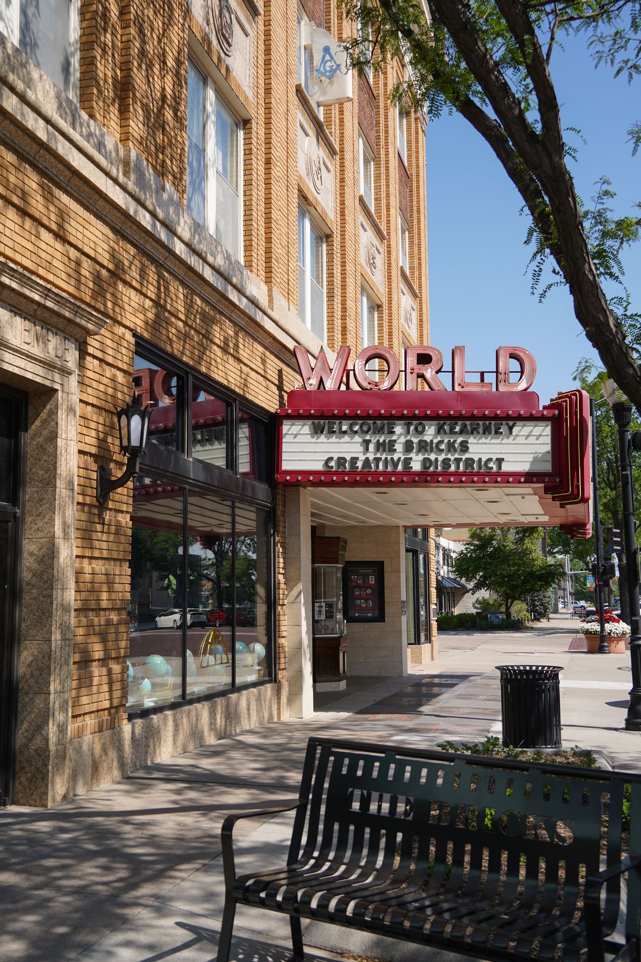 A sign for The World Theater that reads 'Welcome to Kearney The Bricks Creative District'